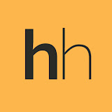 Smiling middle-aged man wearing a dark coat in a warmly lit indoor setting.