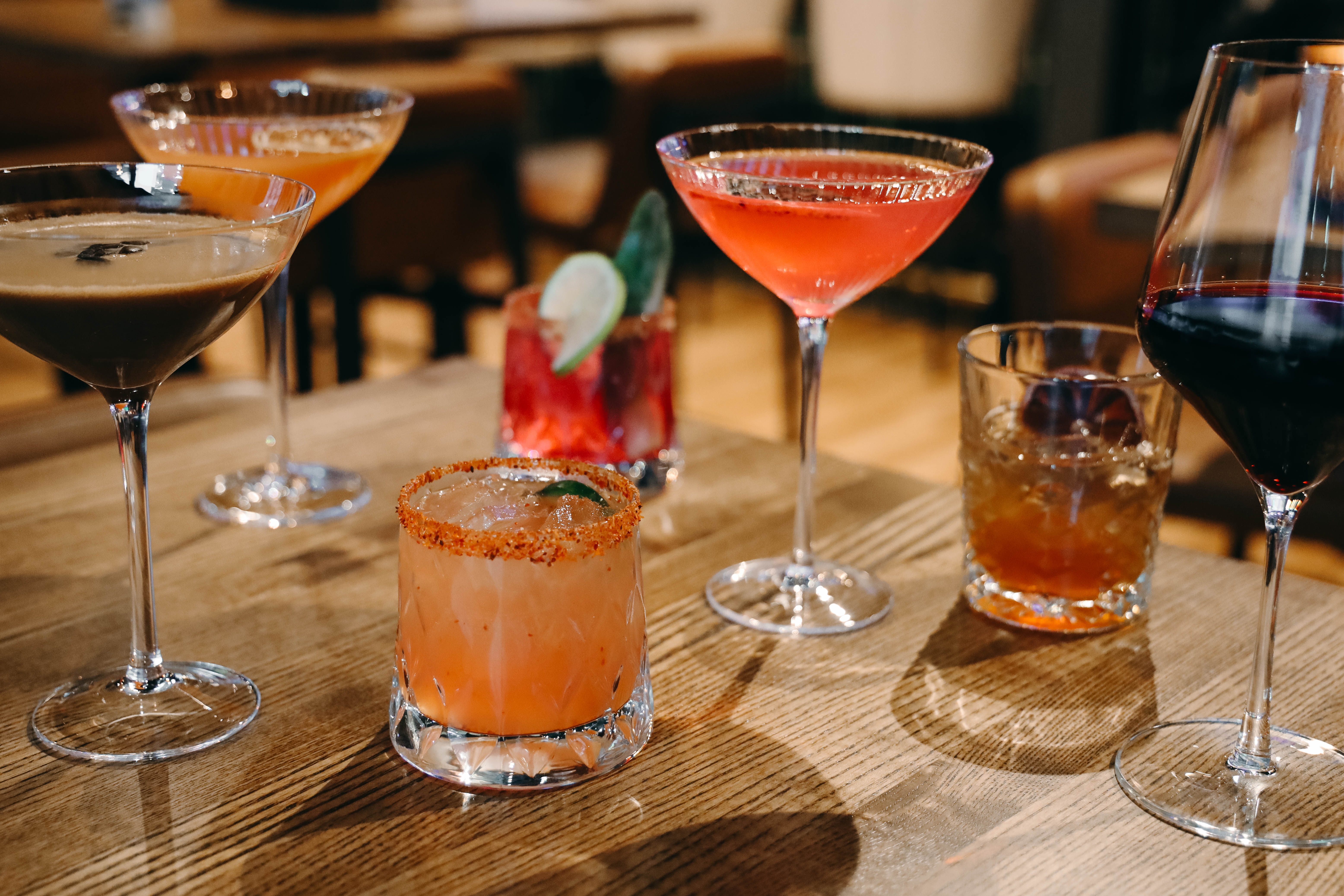 Selection of elevated craft cocktails presented at a restaurant and bar.