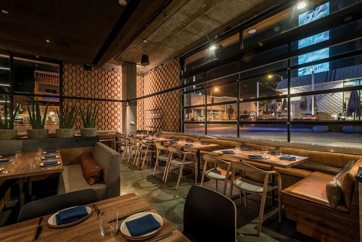 Polished restaurant dining room and bar during service, representing concept development, operational strategy and hospitality business growth.