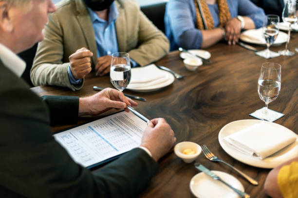 Restaurant operator reviewing recipe costs and profitability data.