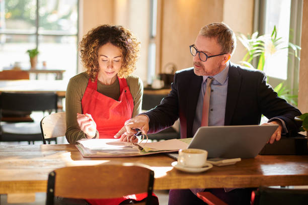 Restaurant operator and consultant reviewing a startup financial model.