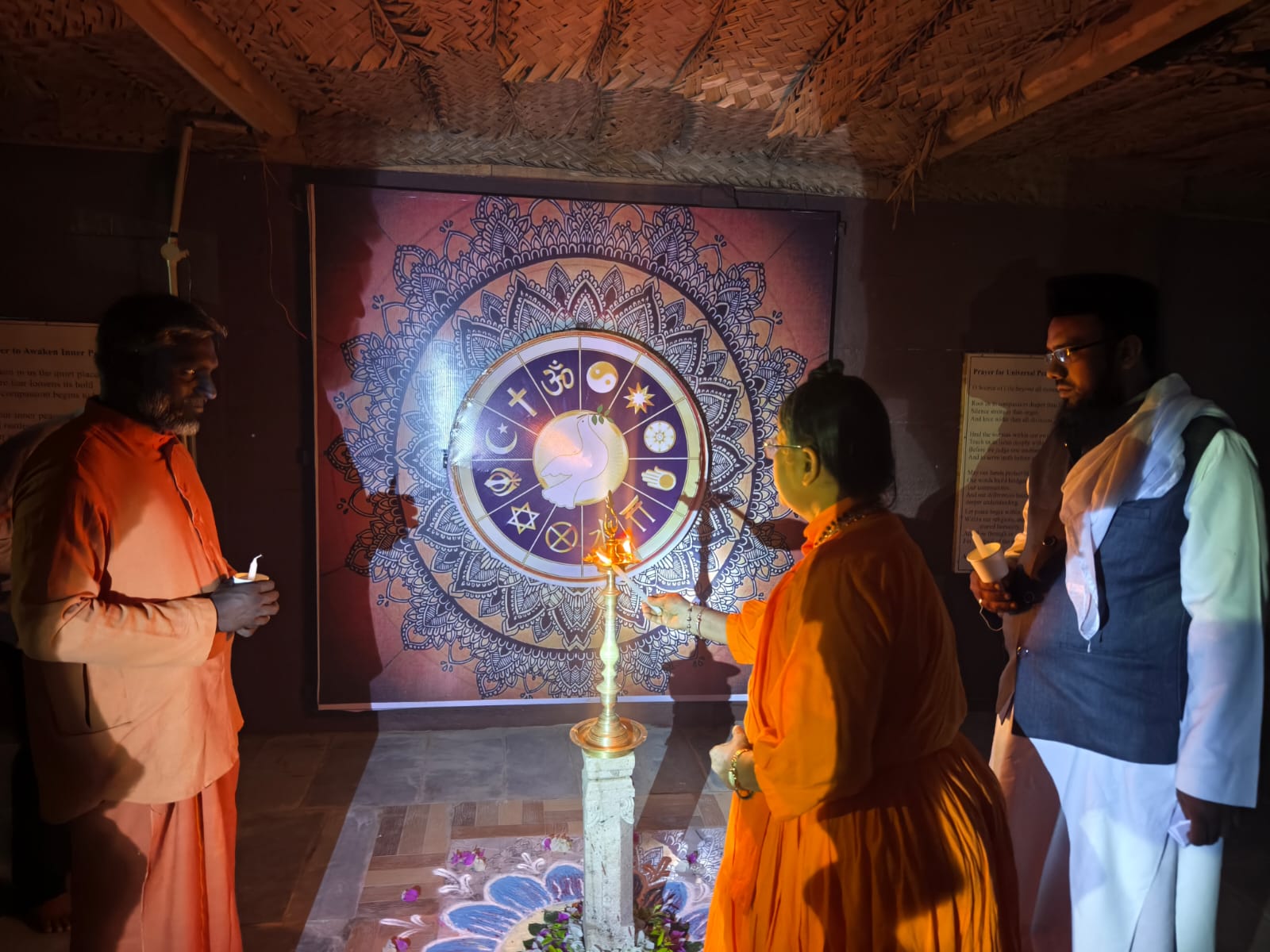 Lighting a lamp in prayer at Saccidananda Ashram, Shantivanam