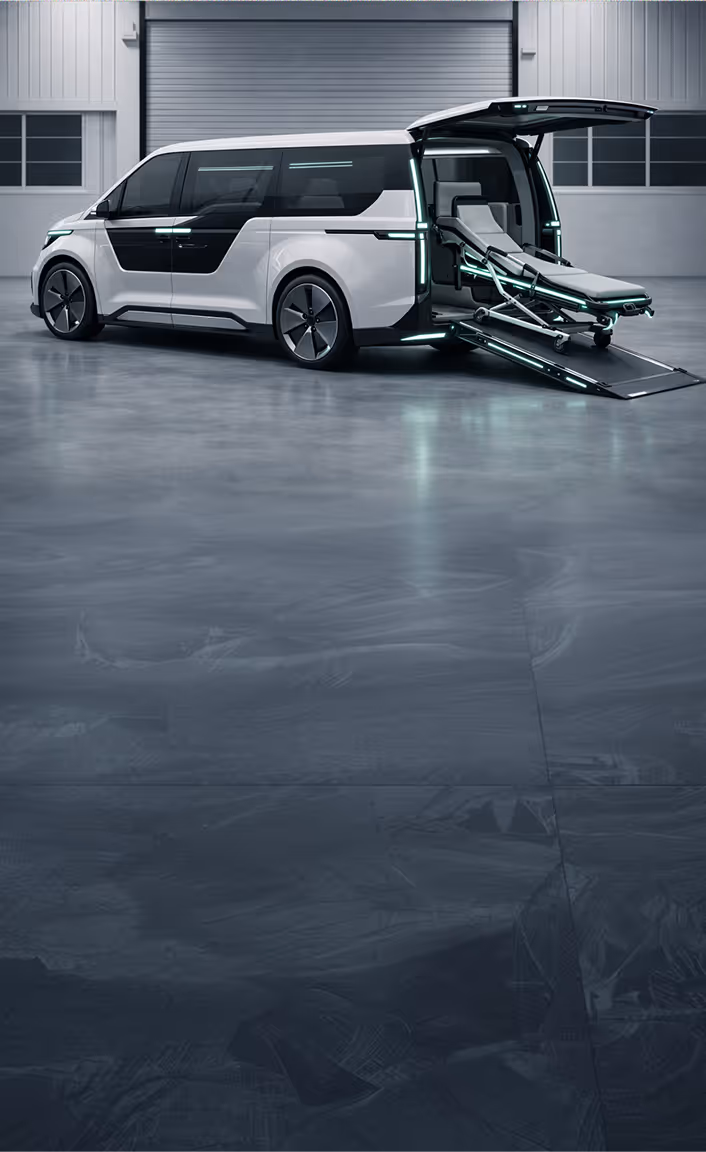 Side view of a silver wheelchair-accessible van with its sliding door and rear hatch open, showing a folded wheelchair and a wheelchair ramp extended.