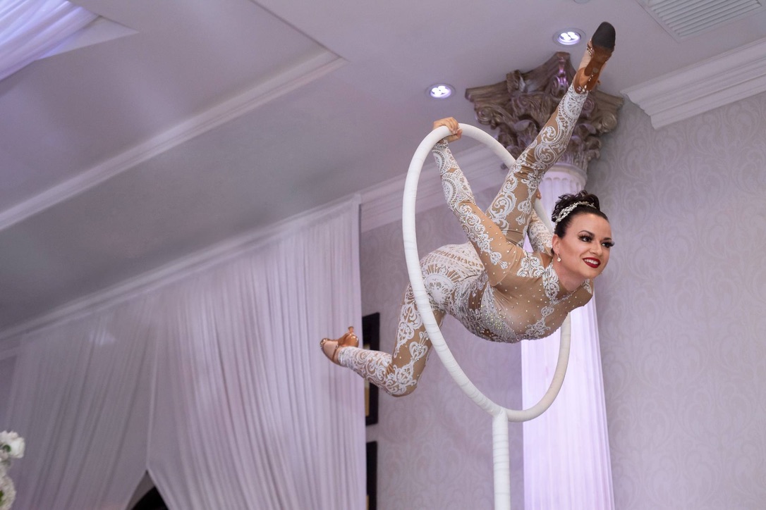 Professional aerialist performing on aerial silks
