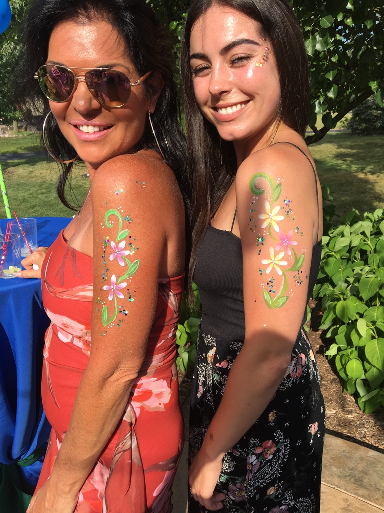 Face painter creating intricate art at a Baltimore festival