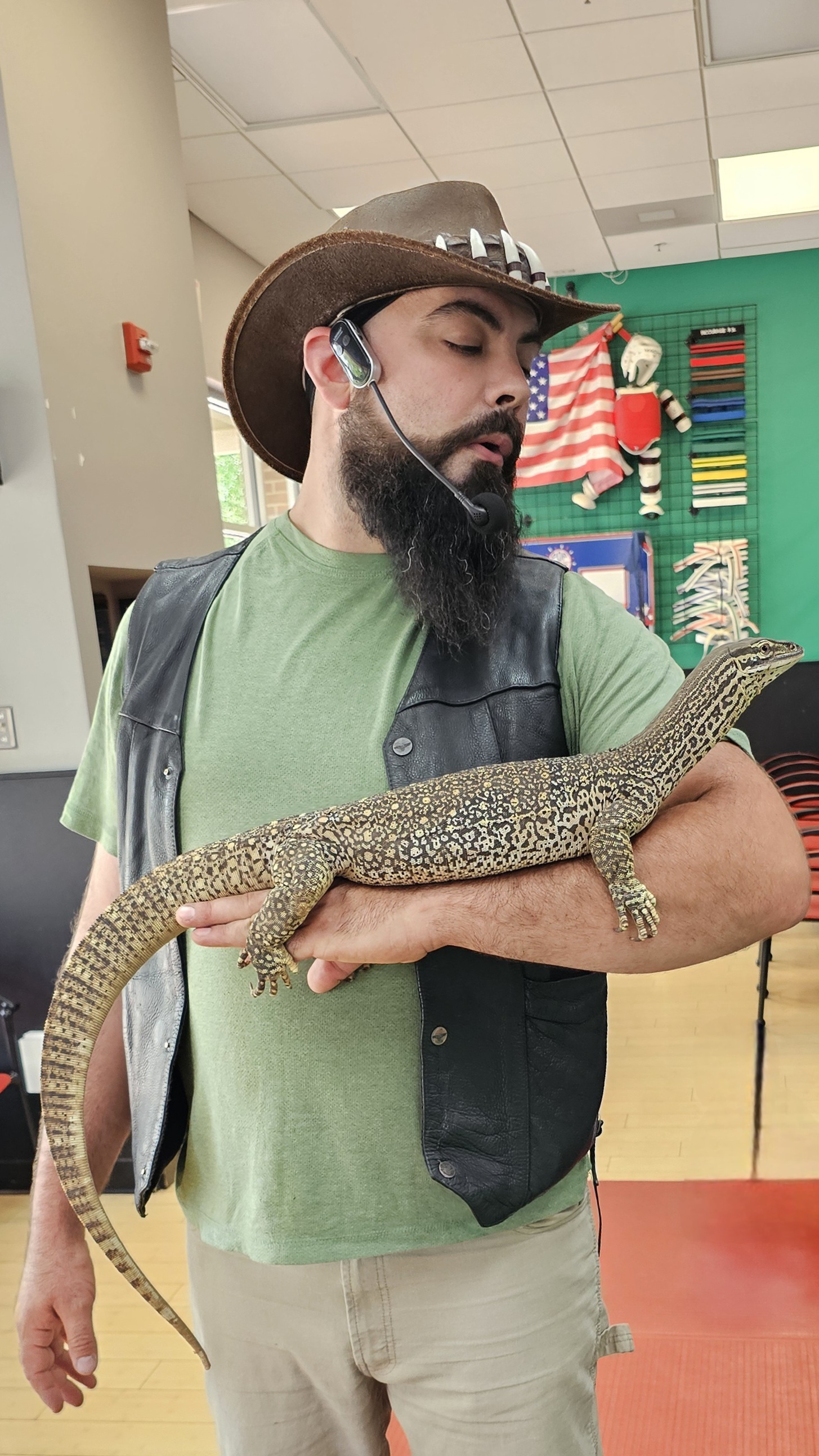 Child interacting with a small mammal at an educational creature show