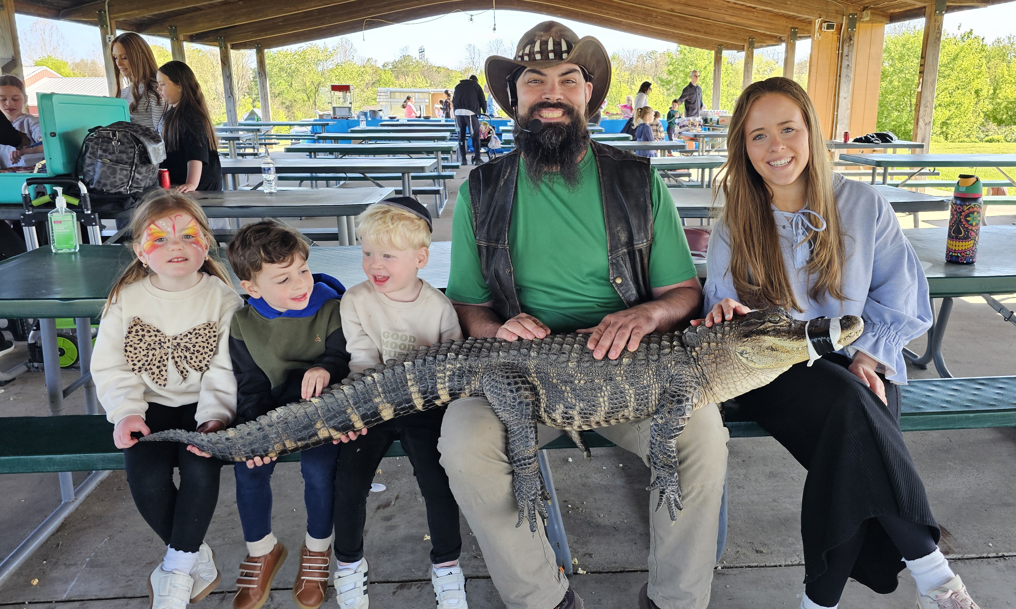 Trained handler holding an exotic reptile for guests