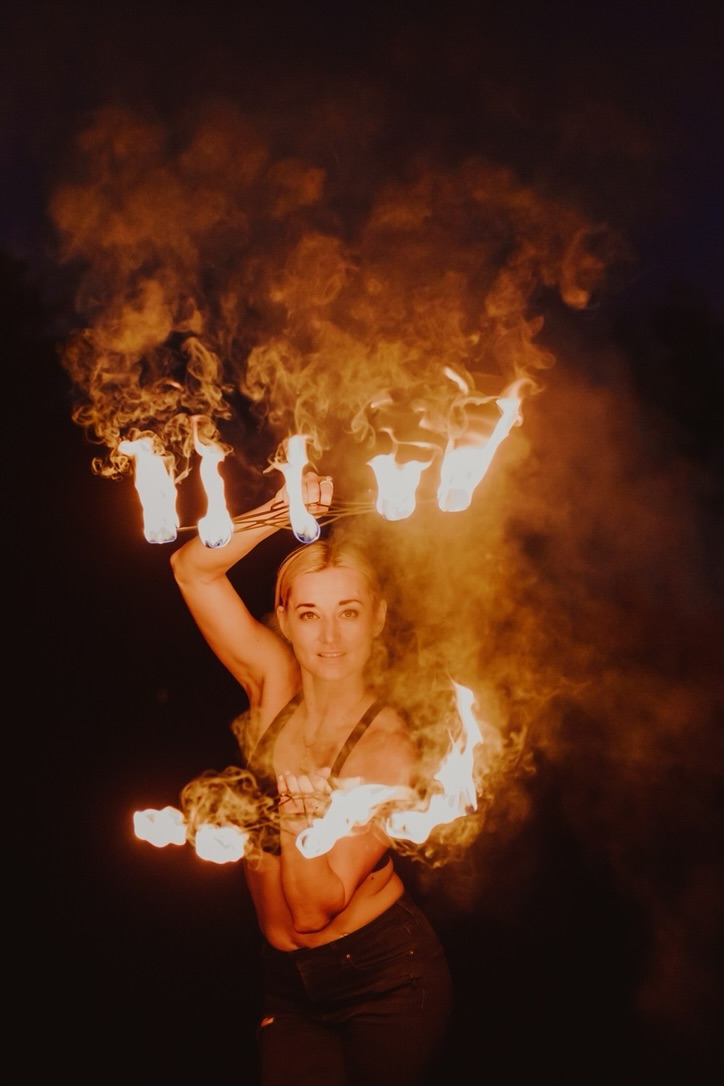 Fire artist with flame fans at a DC corporate finale