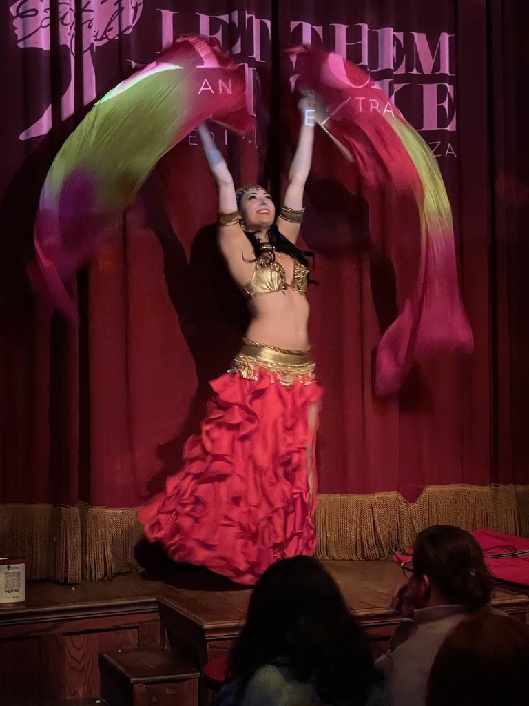 Belly dancer in ornate beaded costume at a corporate event