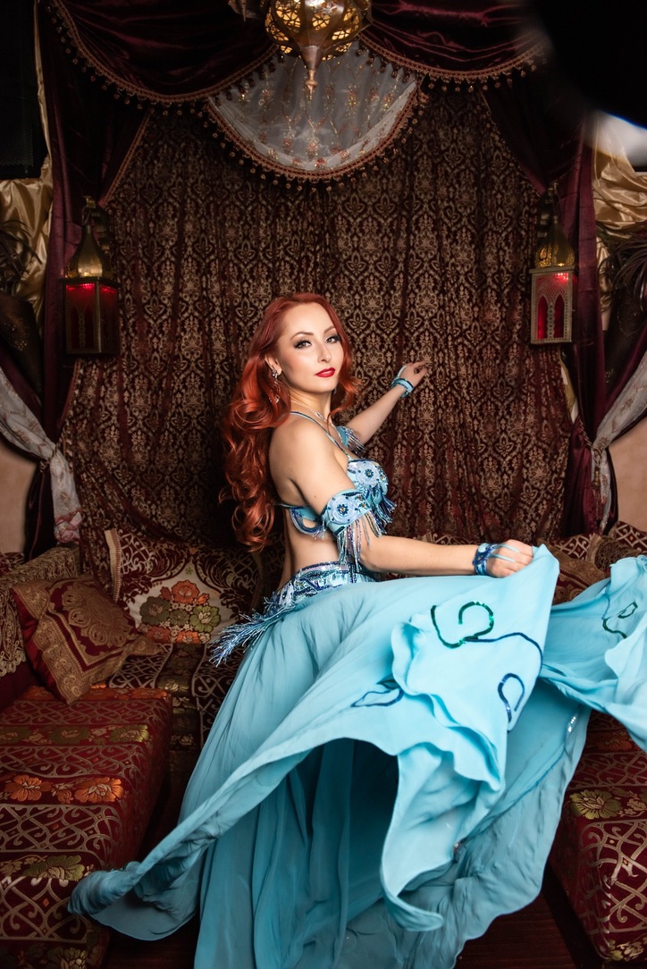 Professional belly dancer in vibrant costume at an event