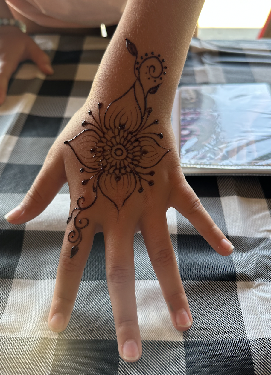 Henna artist creating traditional mehndi at a bridal shower