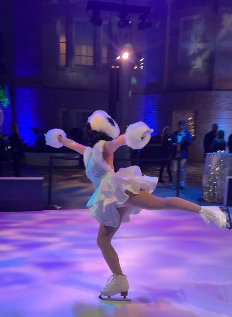 Ice skater performing a spin at a corporate gala
