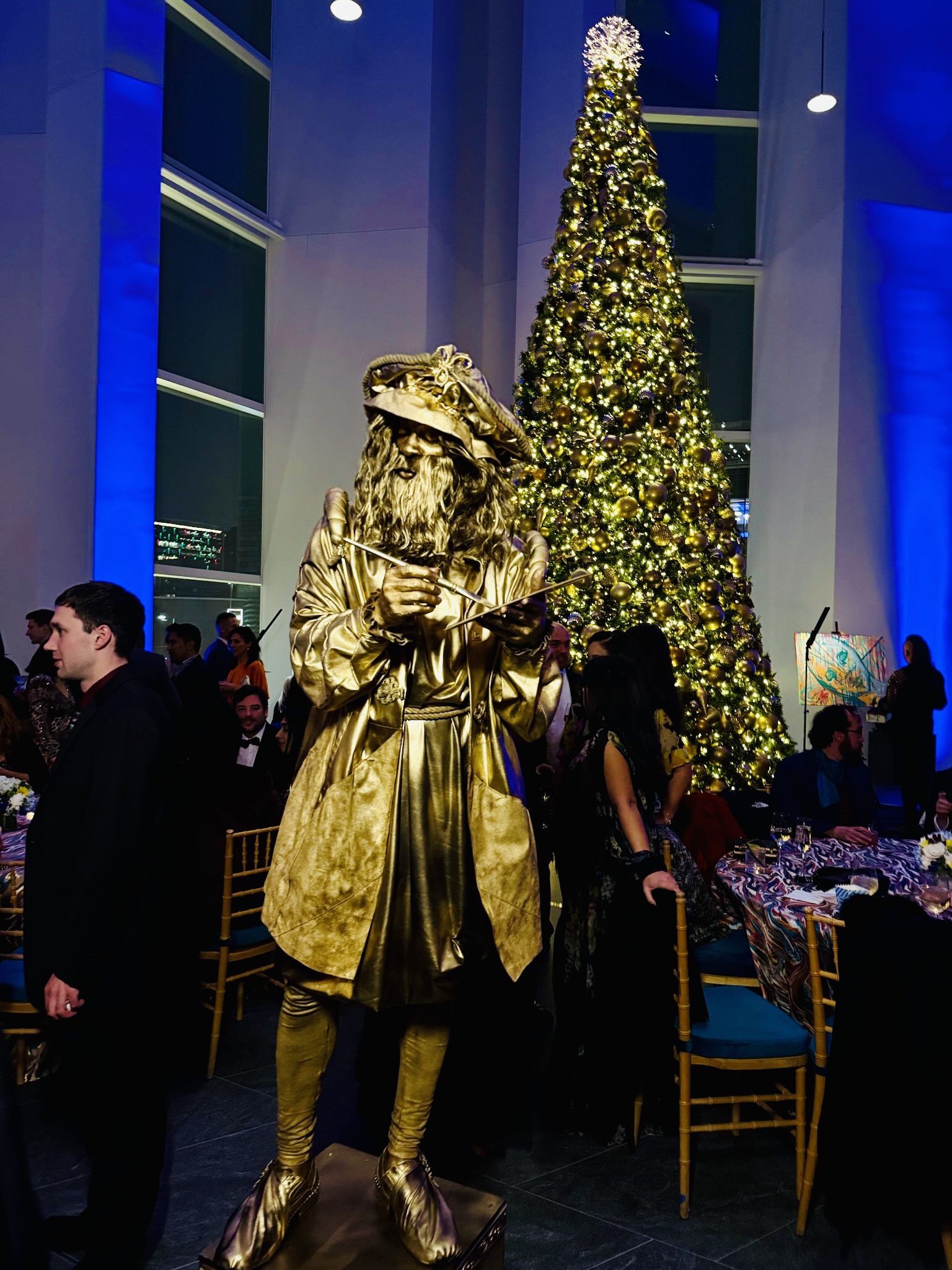Living statue performer in metallic costume at a gala