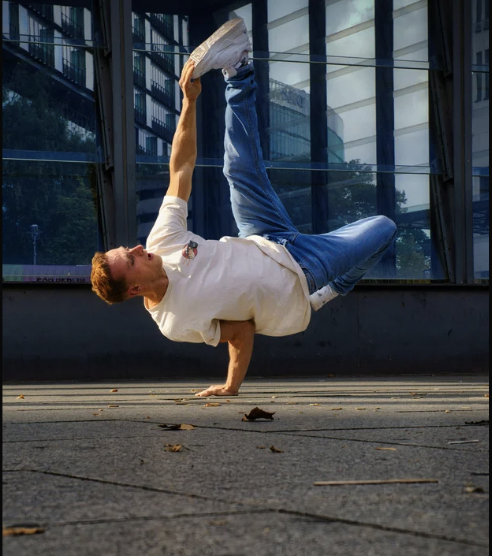 Break dancer performing power moves at an event