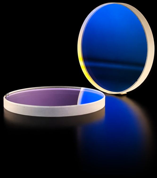 Two circular long pass optical filters — one upright showing a deep royal blue interference coating, and one lying flat with a soft lavender hue, both in unmounted form.