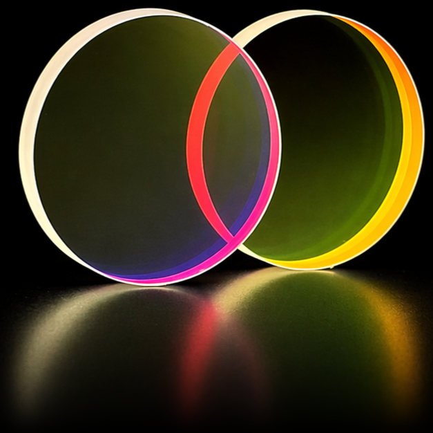 Two circular short pass optical filters overlapping at an angle, one with a dark olive-green coating and one with a vivid red-orange edge, illustrating the filter's spectral cutoff characteristics.