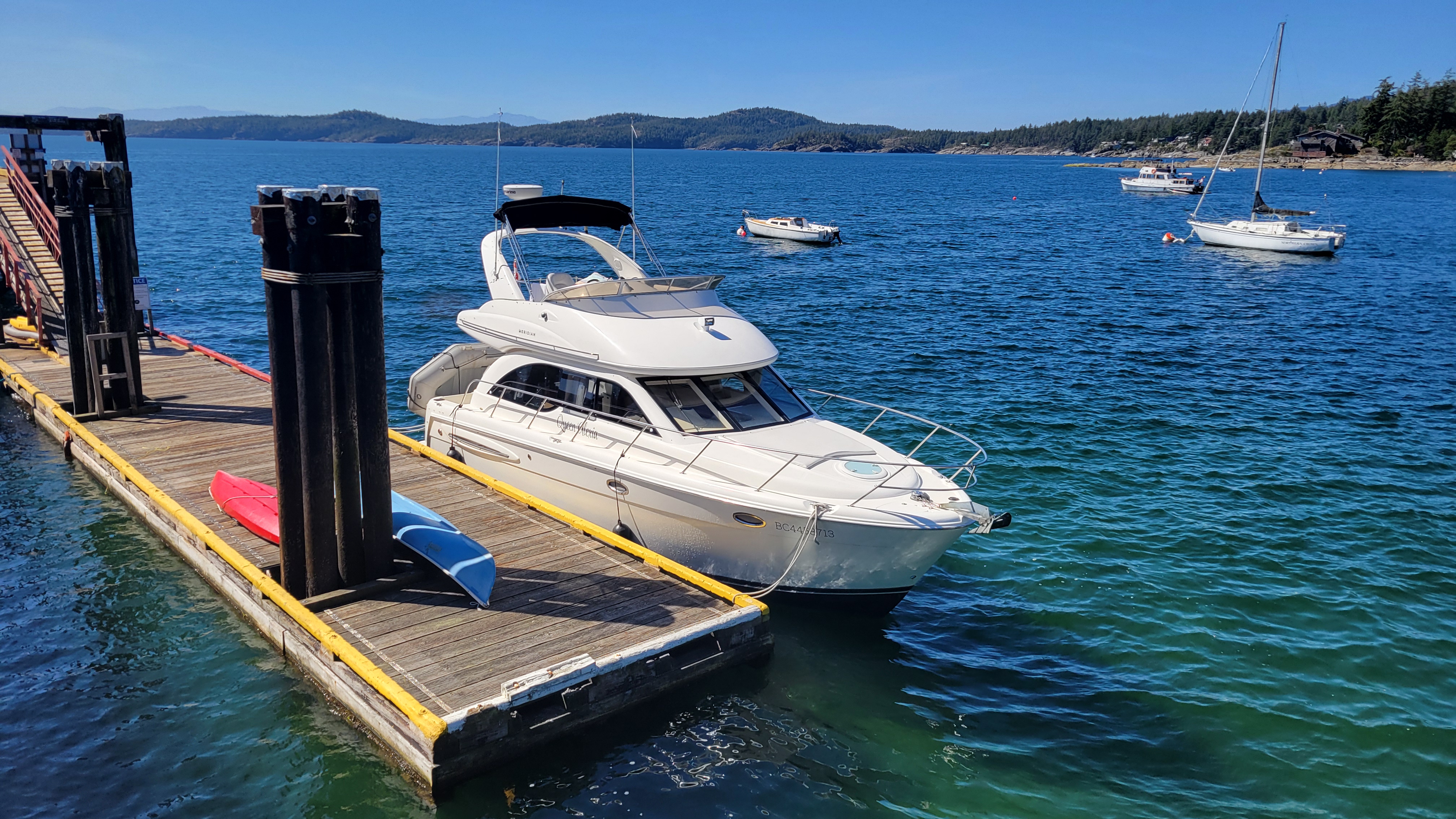 Yacht tied to the dock in wild nature