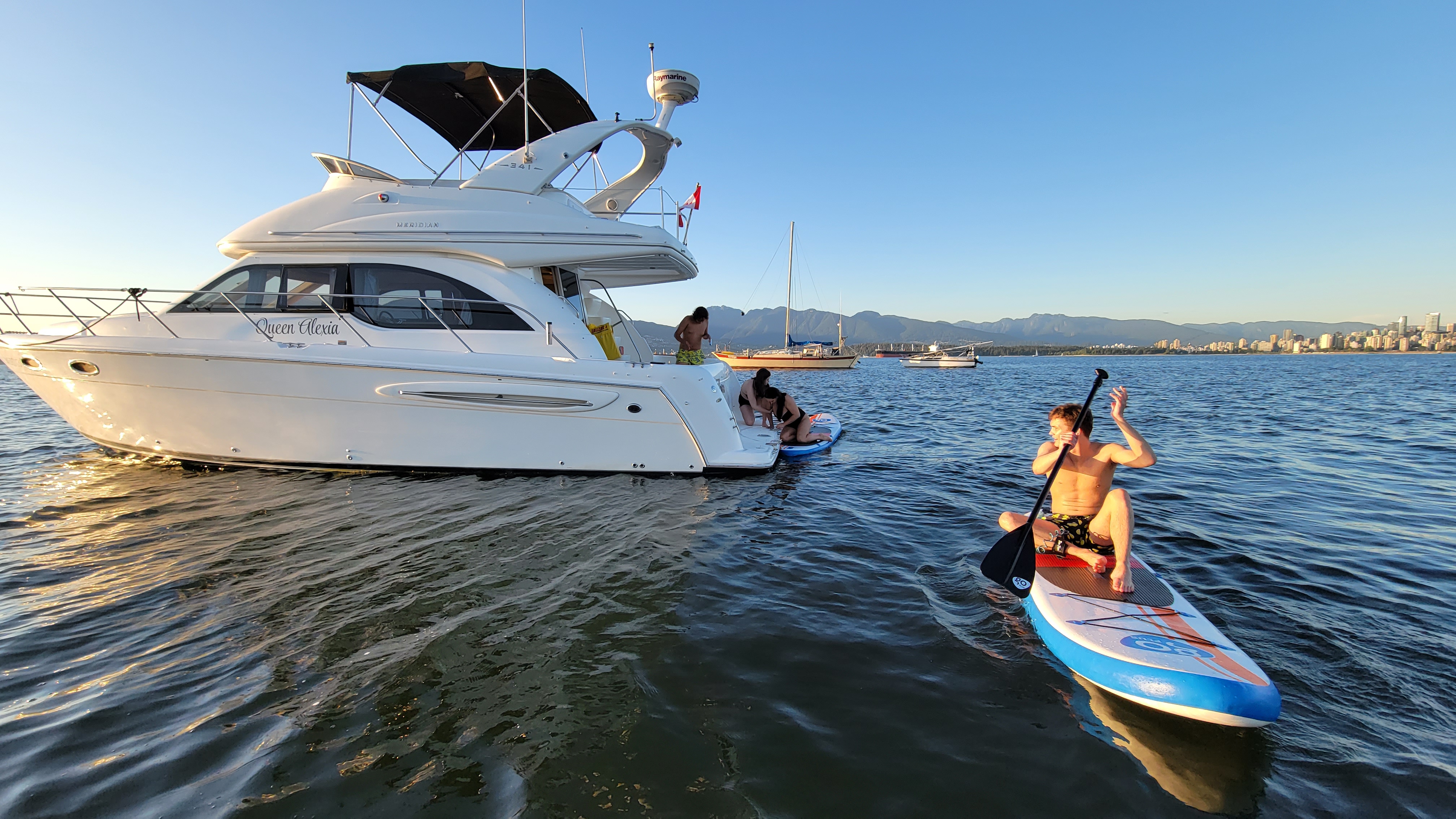 Few people launching a paddleboard from the yacht