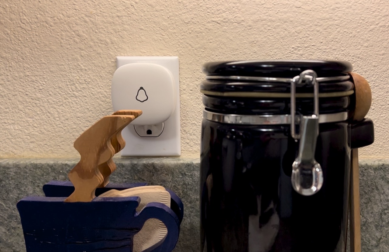 A wireless doorbell receiver placed in the kitchen so it can be heard easily. 