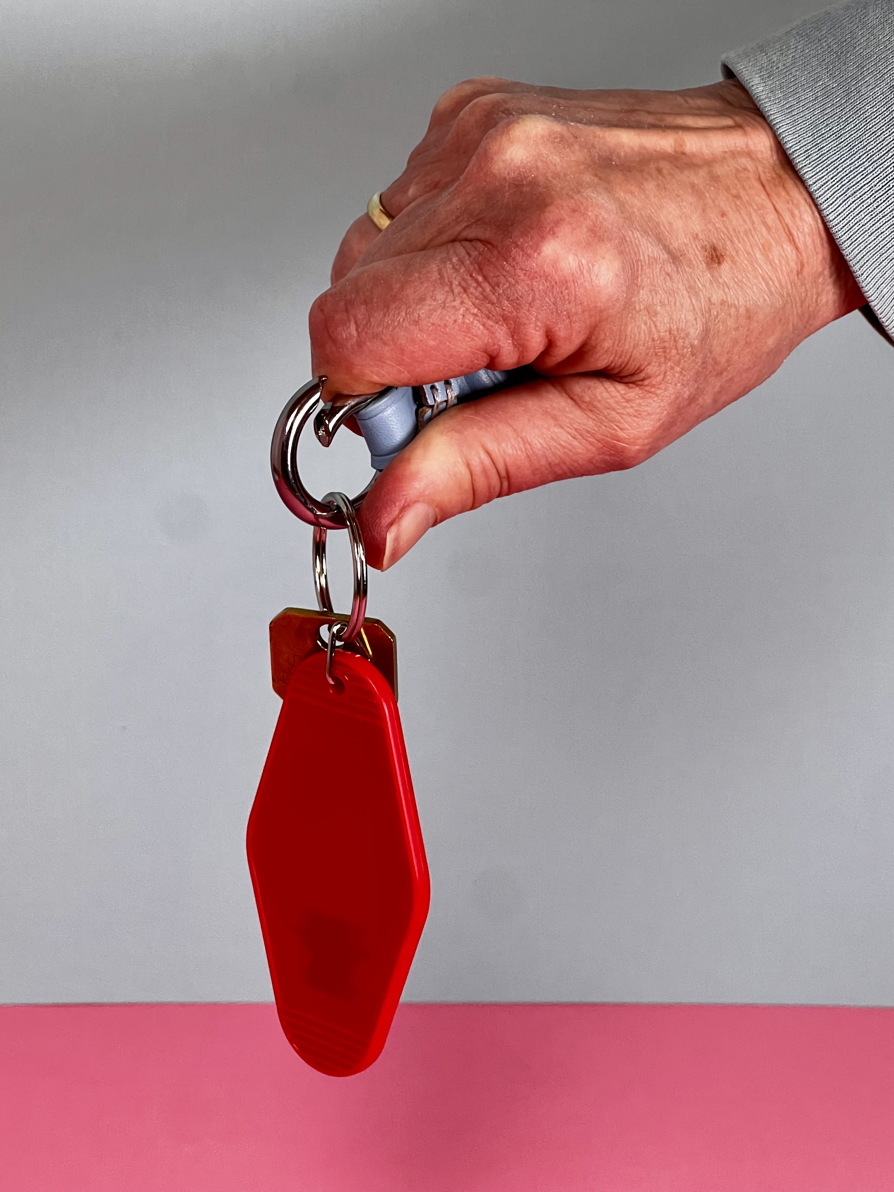 A hand demonstrating the easy opening of a key ring