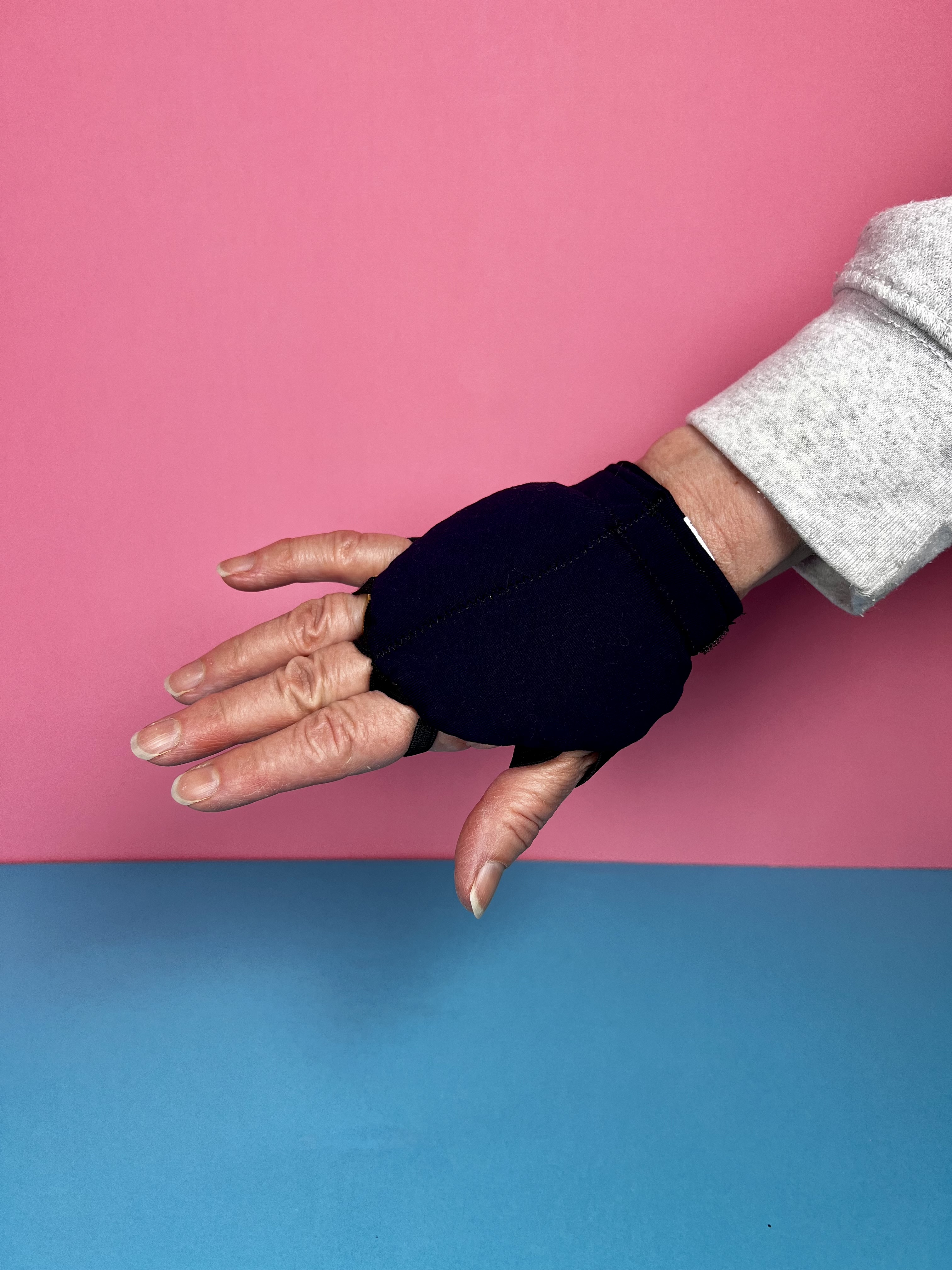 a hand showing weighted glove for tremor