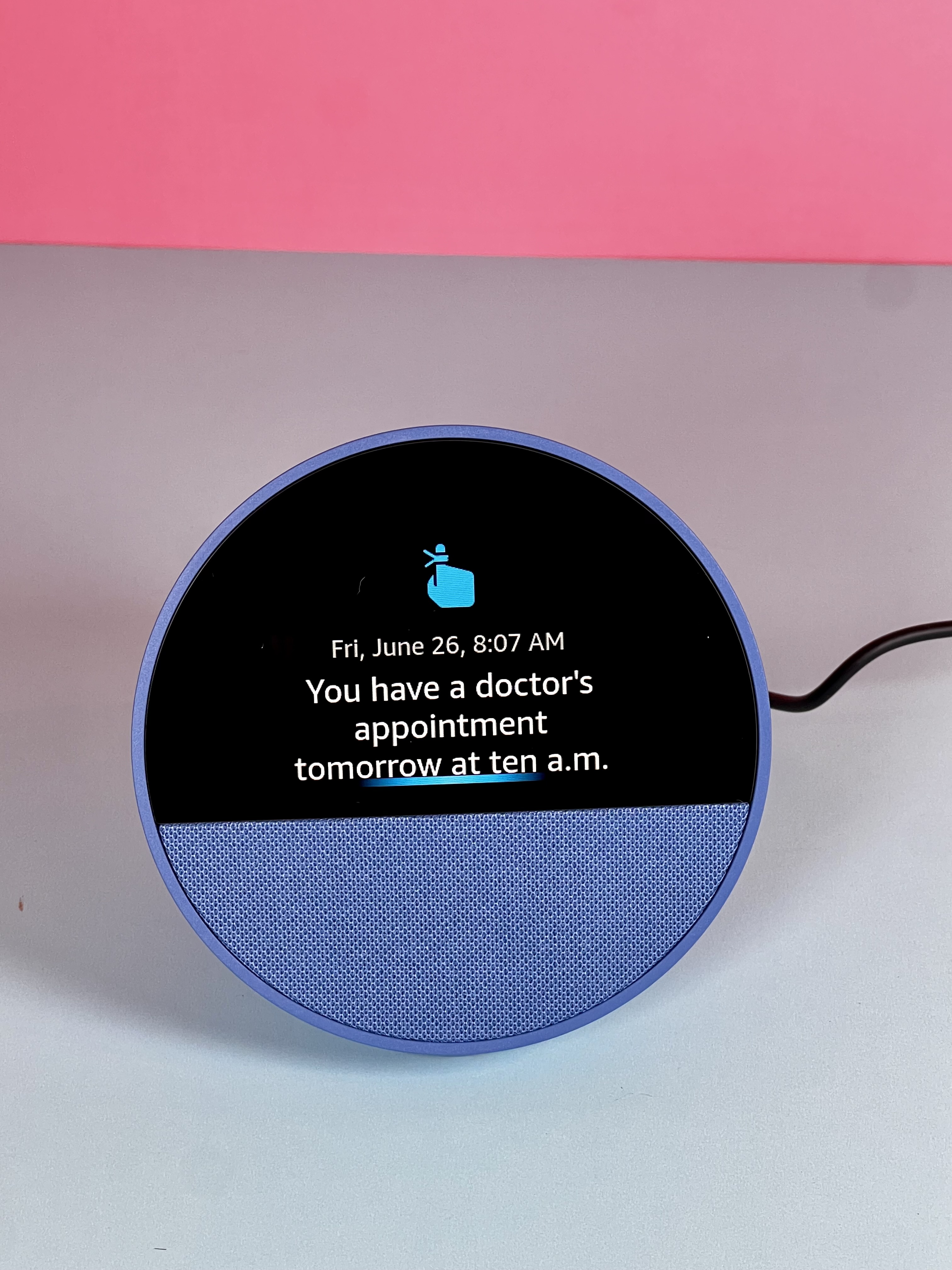 Alexa device with a screen showing a doctor’s appointment reminder for the next day.