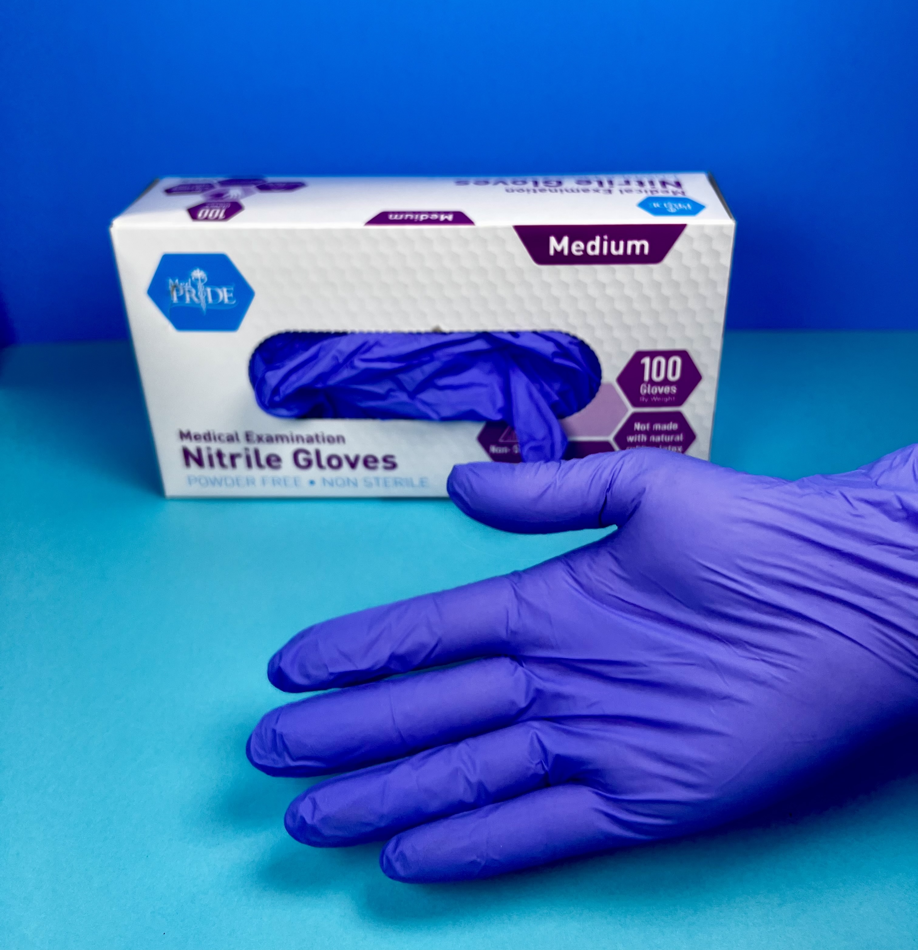 Person wearing a black weighted glove designed to help steady hand tremors.