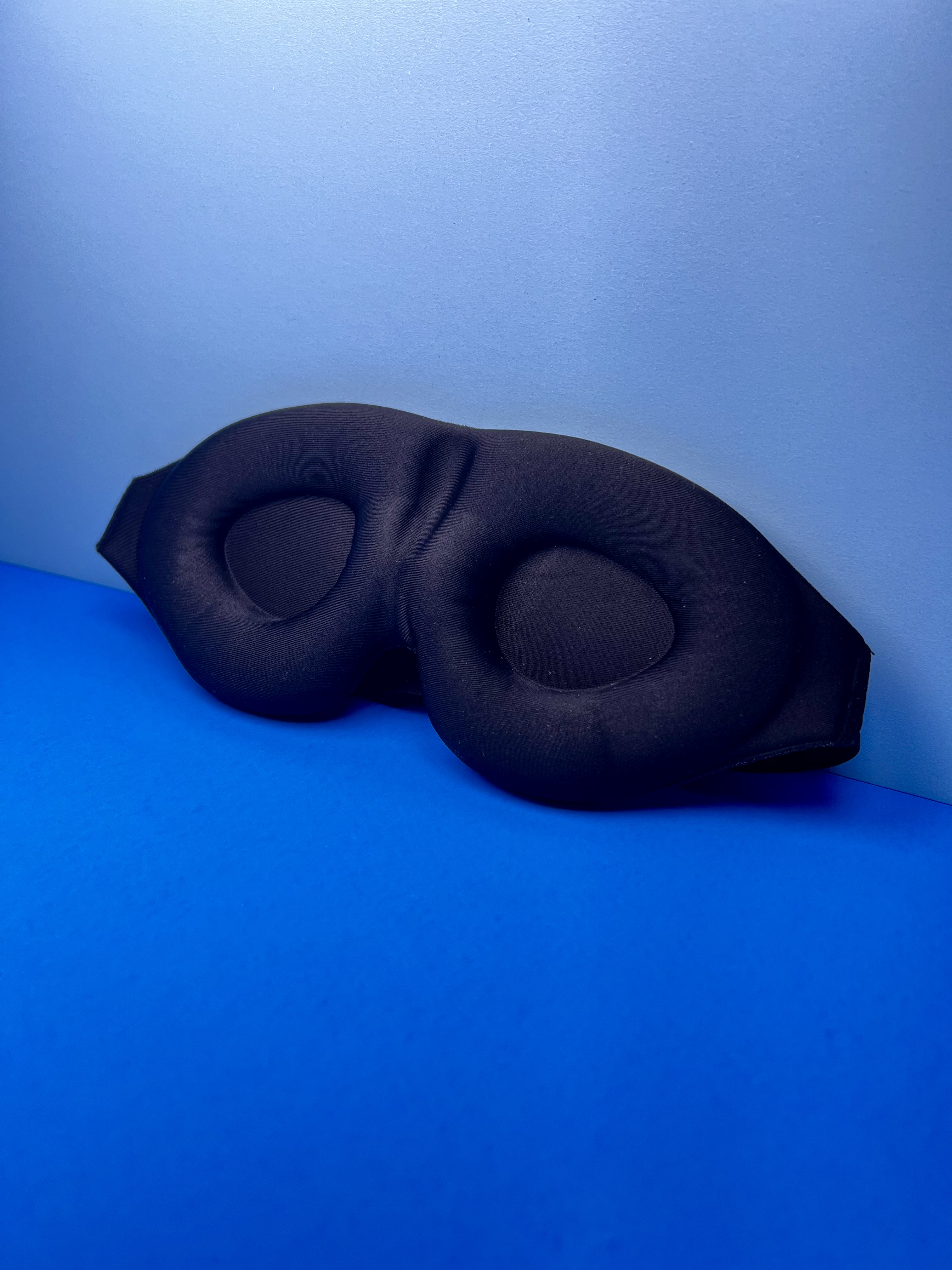 Person wearing a black weighted glove designed to help steady hand tremors.