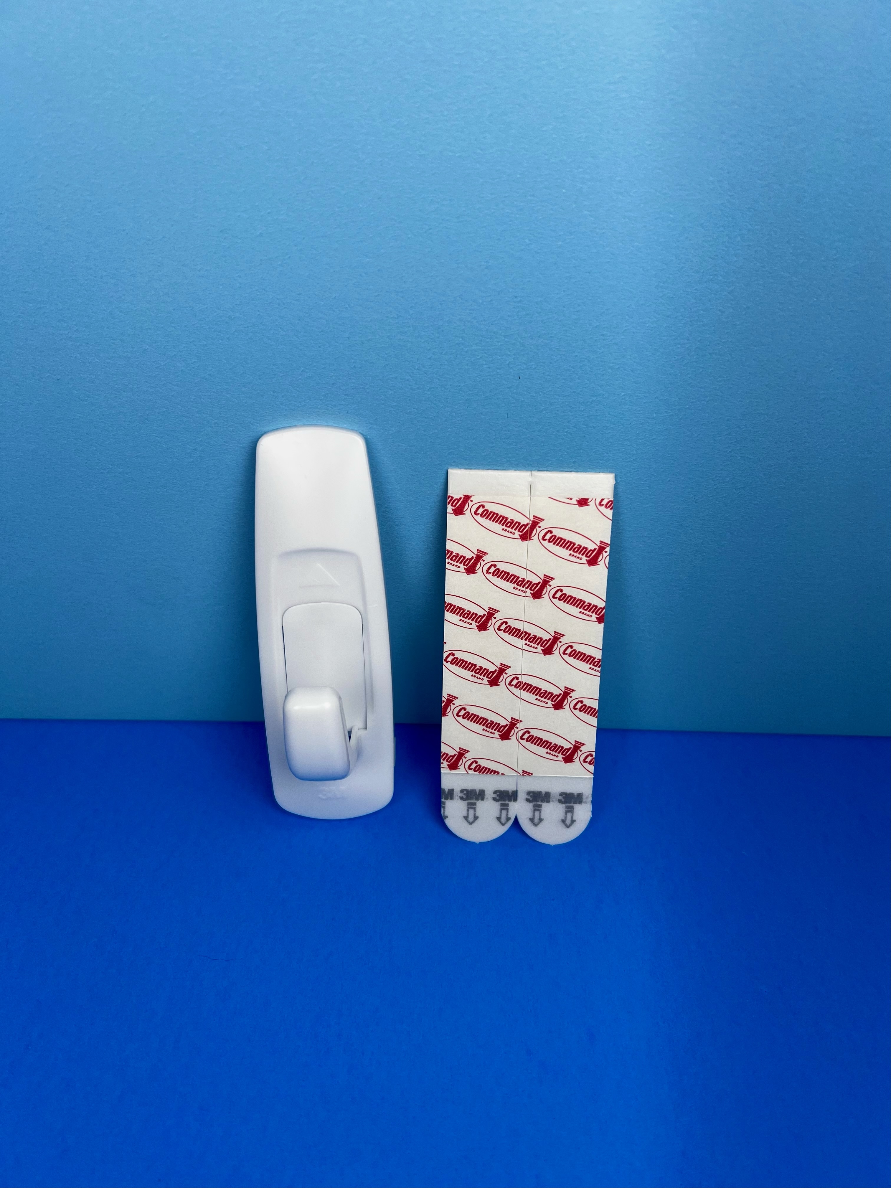 Person pressing the button on a colorful AM and PM pill organizer.