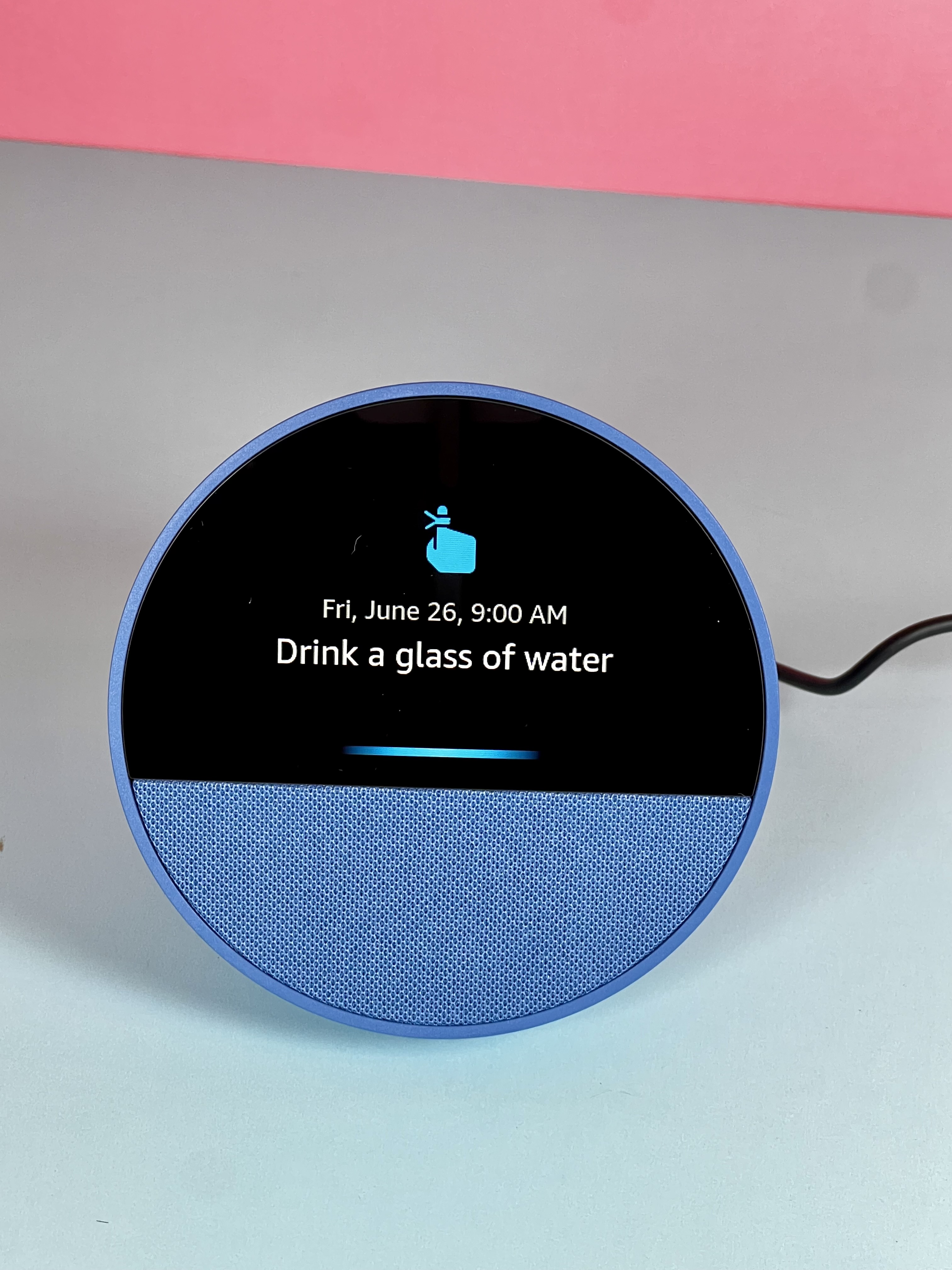 Amazon Echo Show displaying a reminder to drink a glass of water