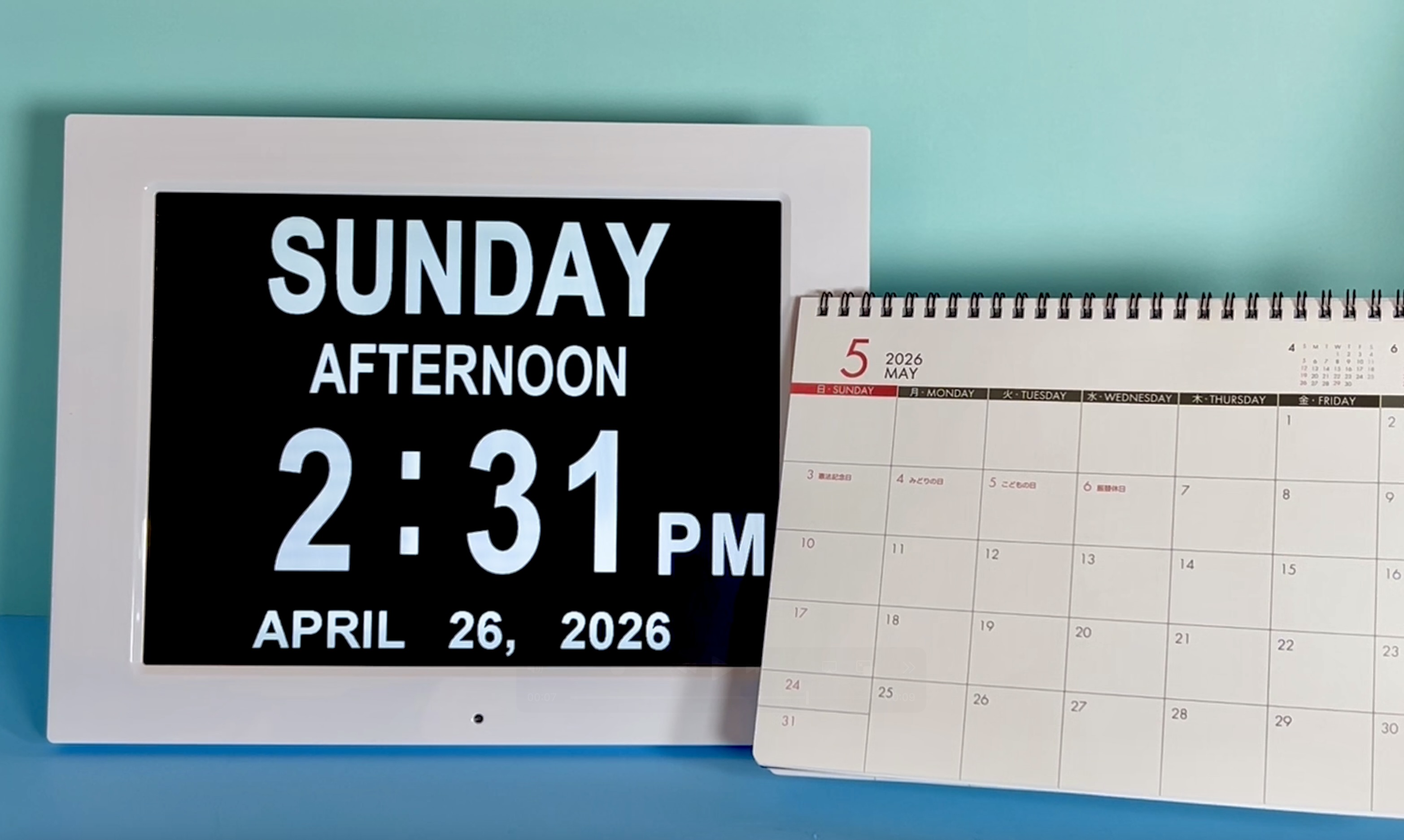 Digital day clock beside a monthly calendar to help keep track of appointments.