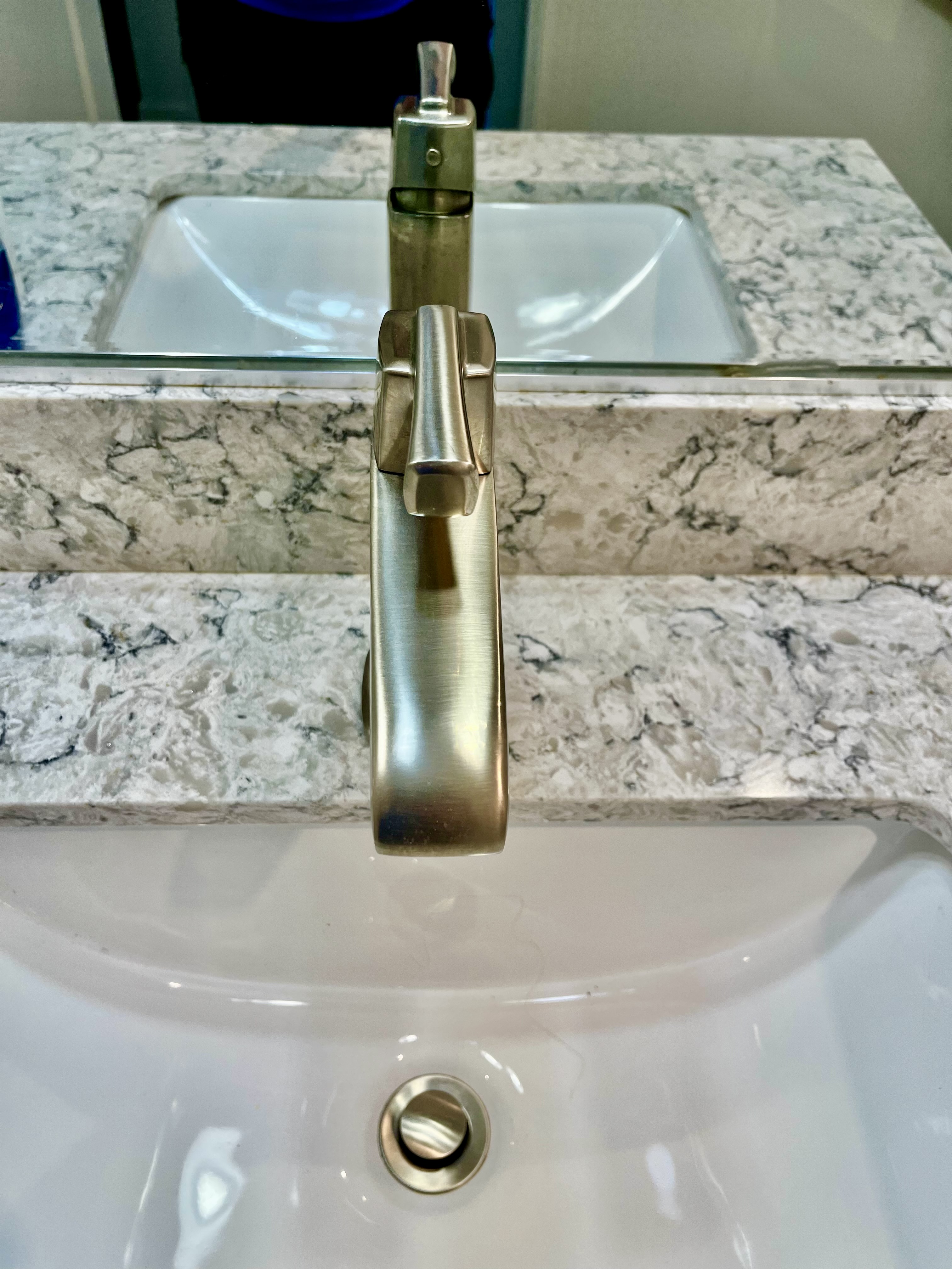 Close-up of a brushed-metal bathroom faucet with one lever.