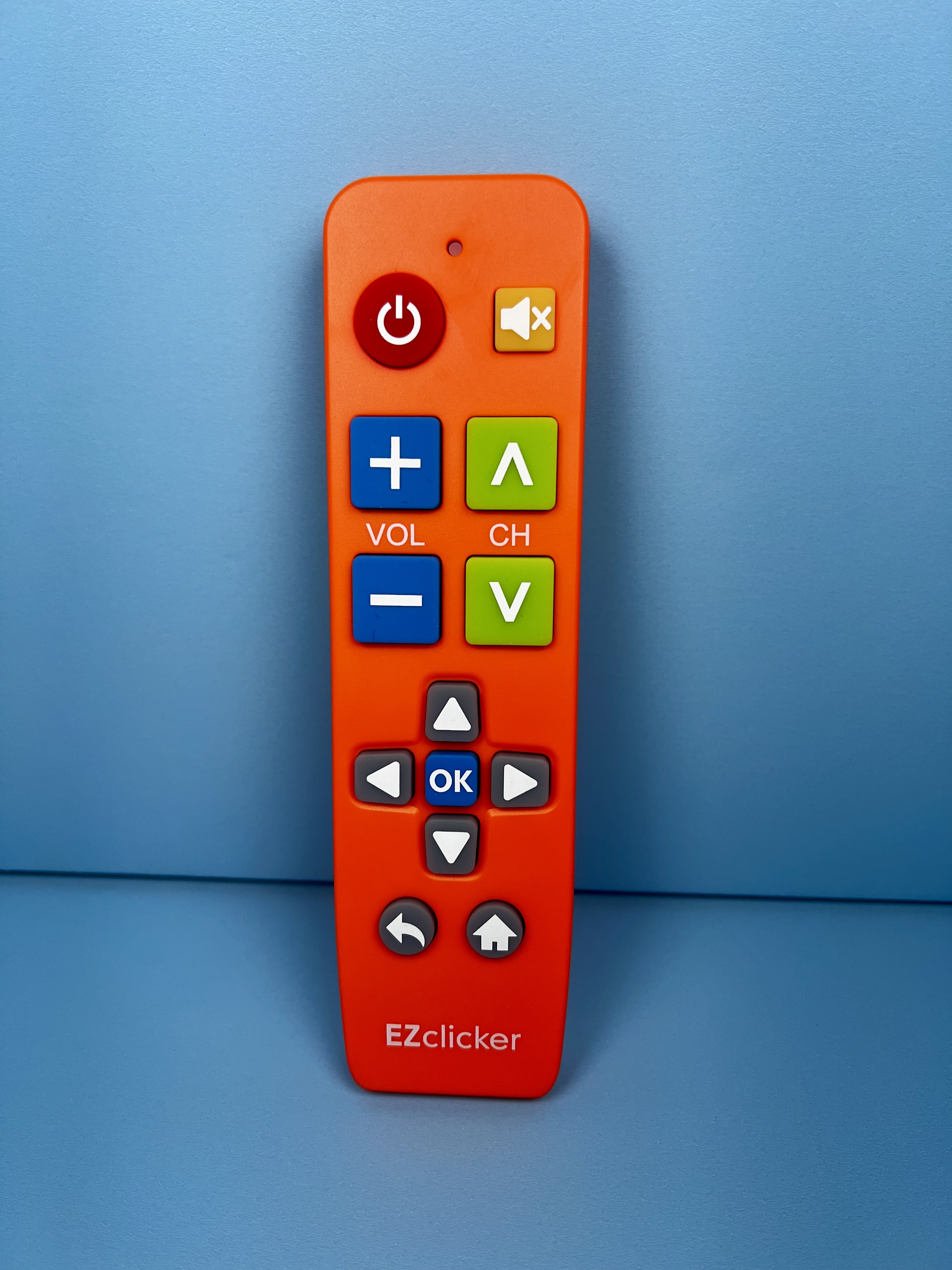 Orange EZclicker remote with fewer, larger, high-contrast buttons for volume, channels, navigation, power, and mute.