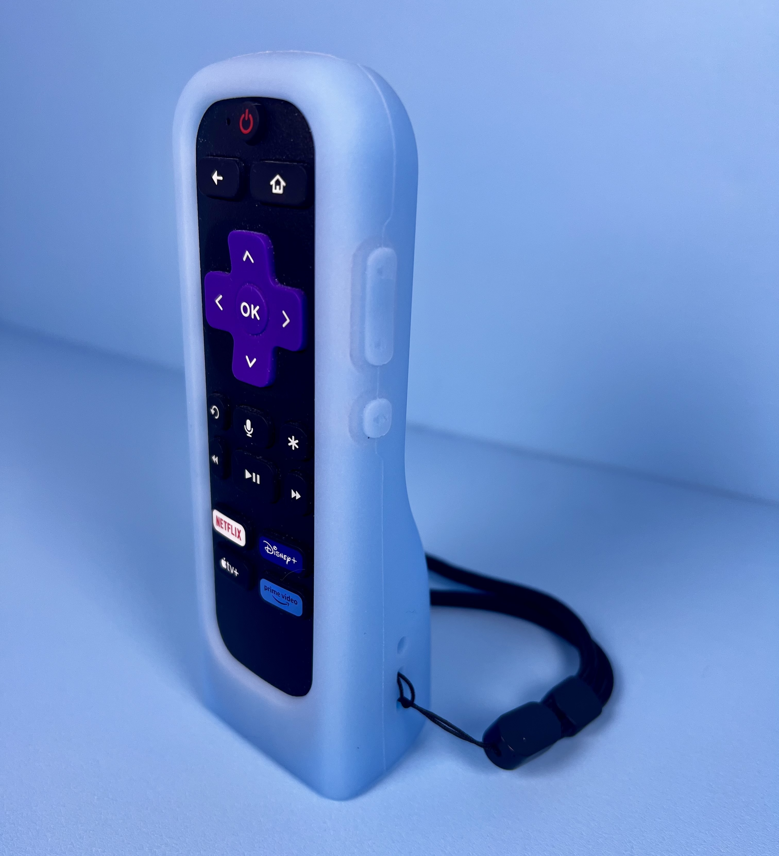 Roku remote standing upright in a thick light-blue protective case with a black wrist strap.