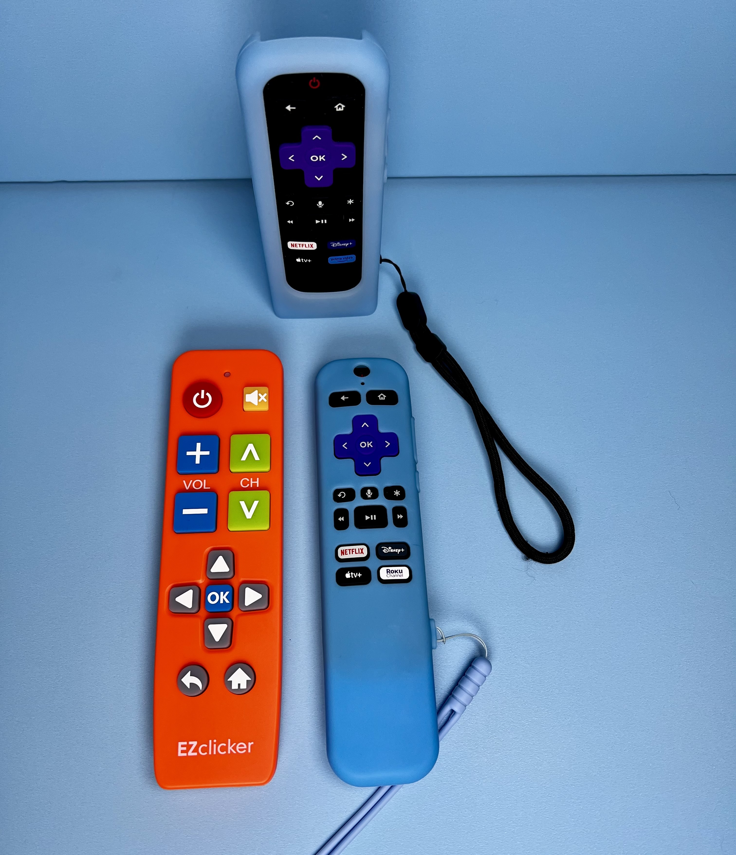 Three remotes against a blue background.