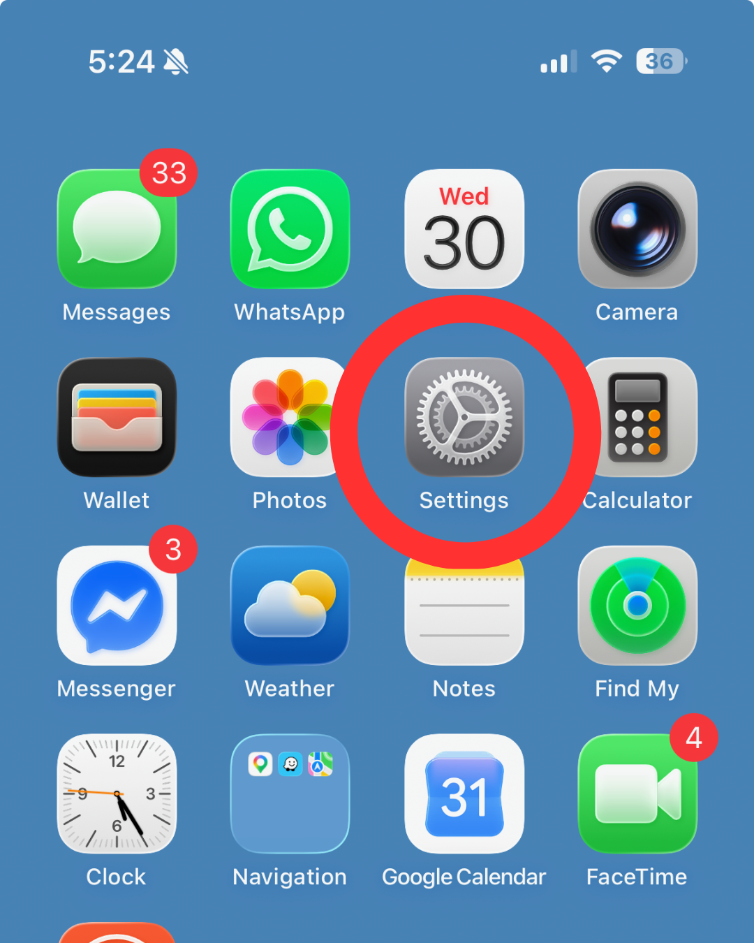 iPhone home screen featuring the Settings gear icon highlighted inside a red circle.