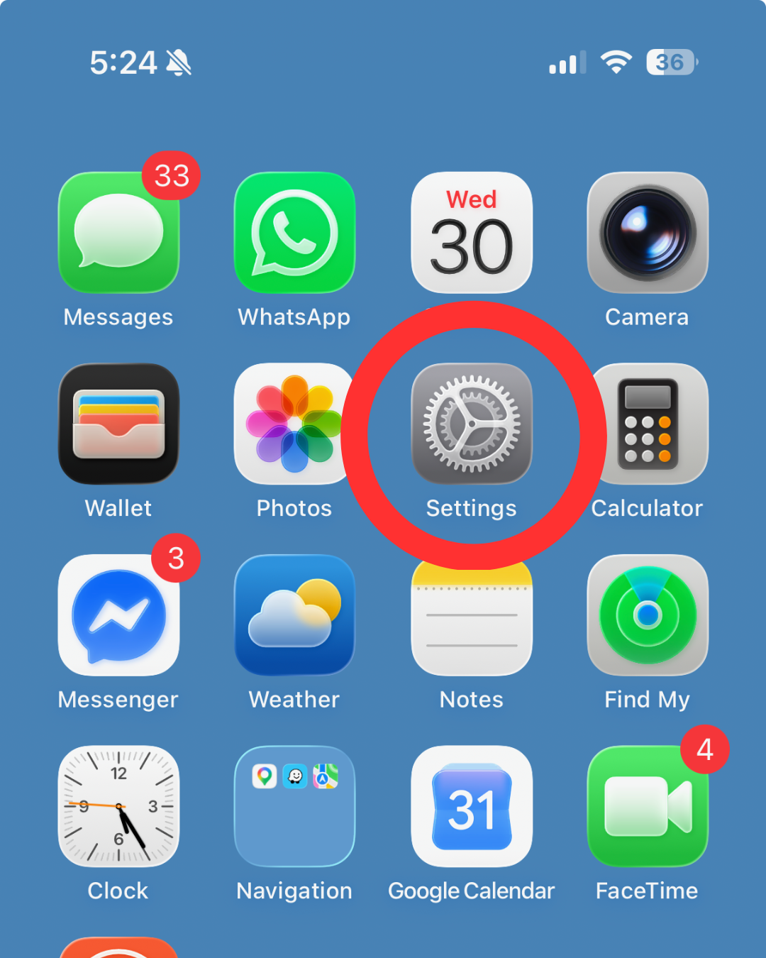 An iPhone home screen displaying app icons, with a red circle highlighting the grey gear icon for the Settings app.