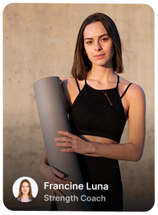 Woman in black sportswear holding a rolled yoga mat, identified as Francine Luna, Strength Coach.