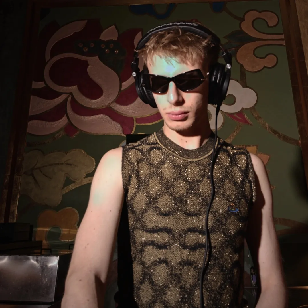 DJ in sunglasses and headphones playing at a summer party in Milan