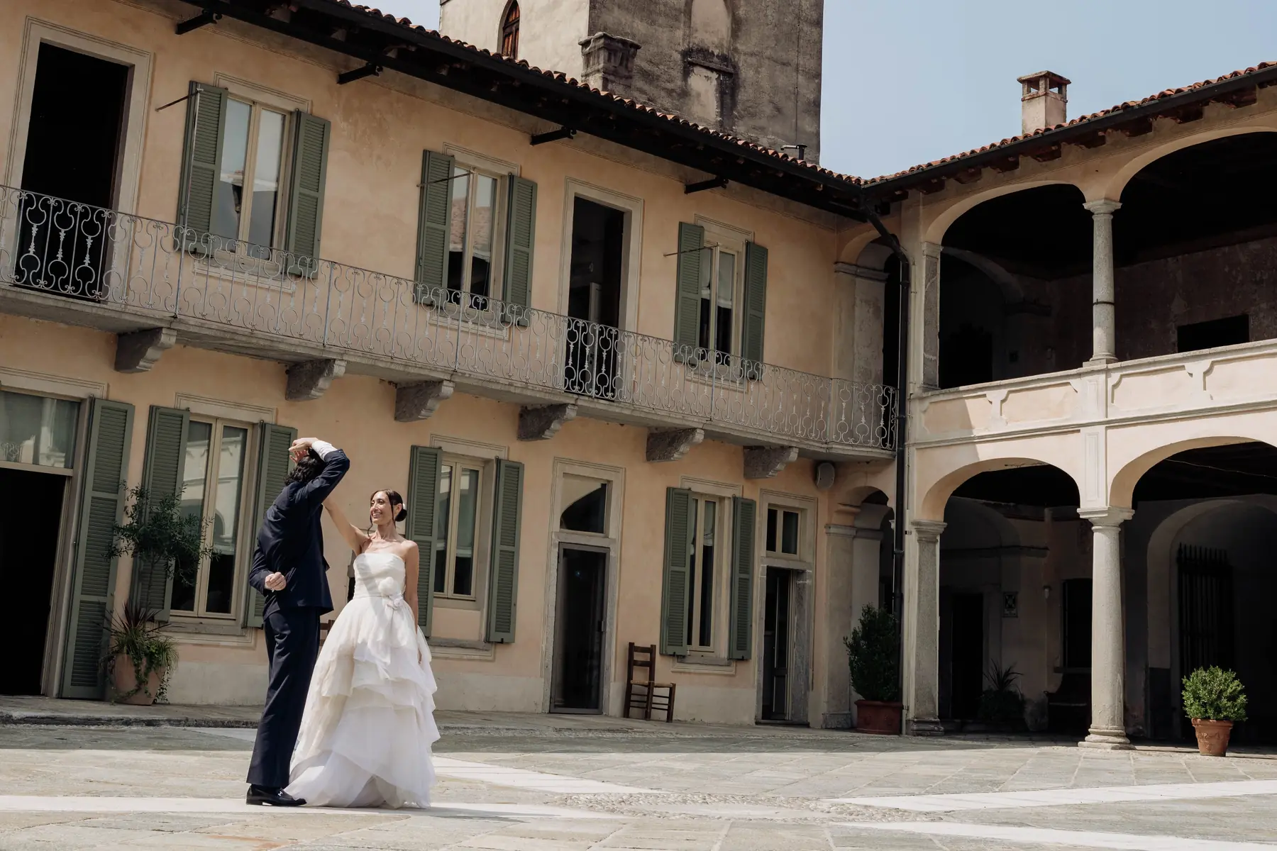 Bride and groom in the courtyard of a historic villa with loggia, Lake Maggiore wedding