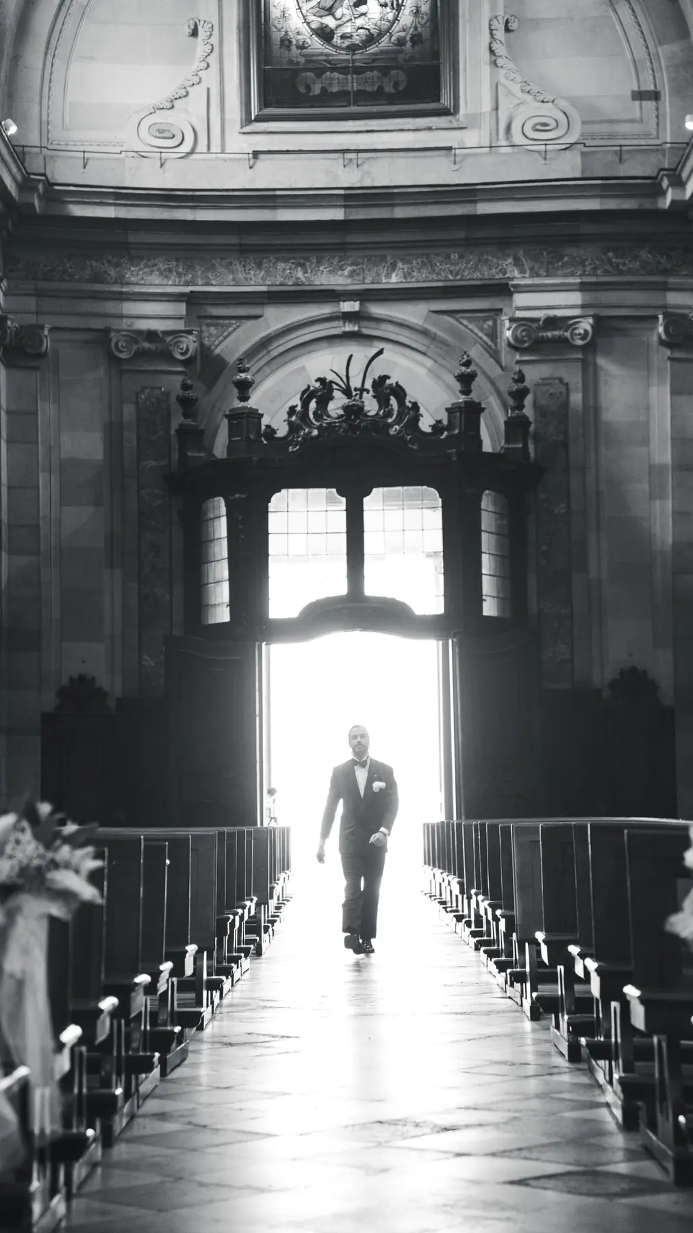 Groom walking down the church aisle in black and white, wedding ceremony in Italy