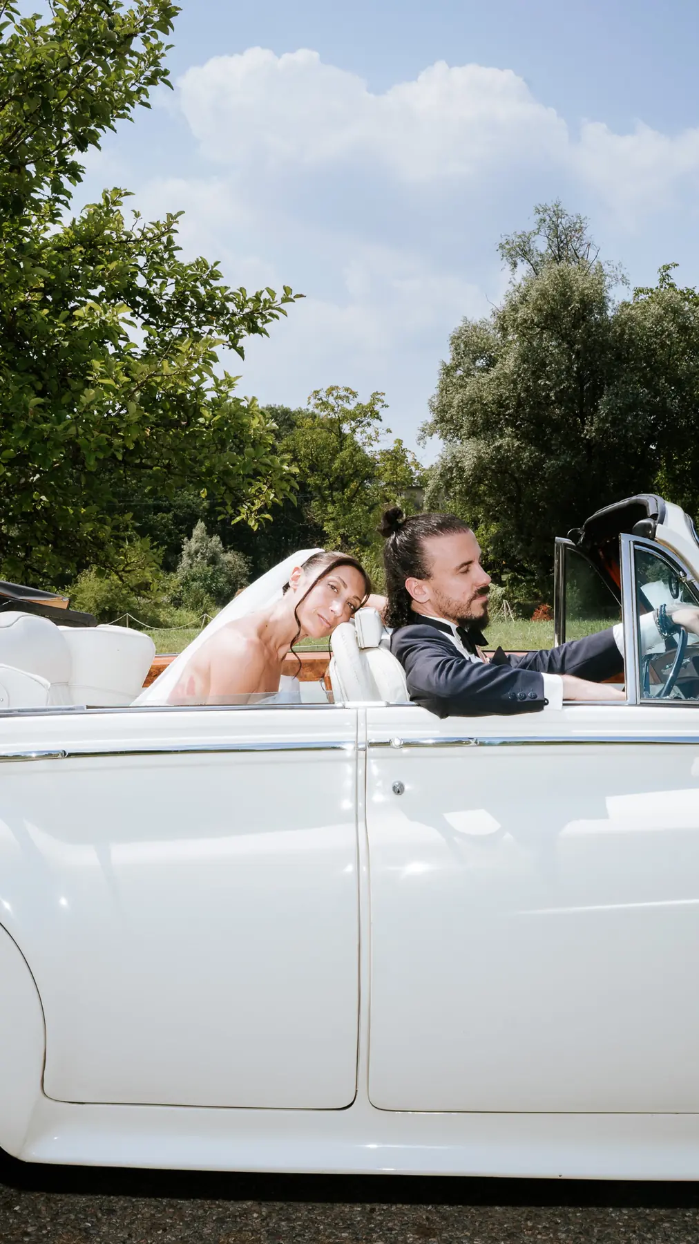 Newlyweds in an open-top vintage Rolls-Royce, wedding on Lake Maggiore