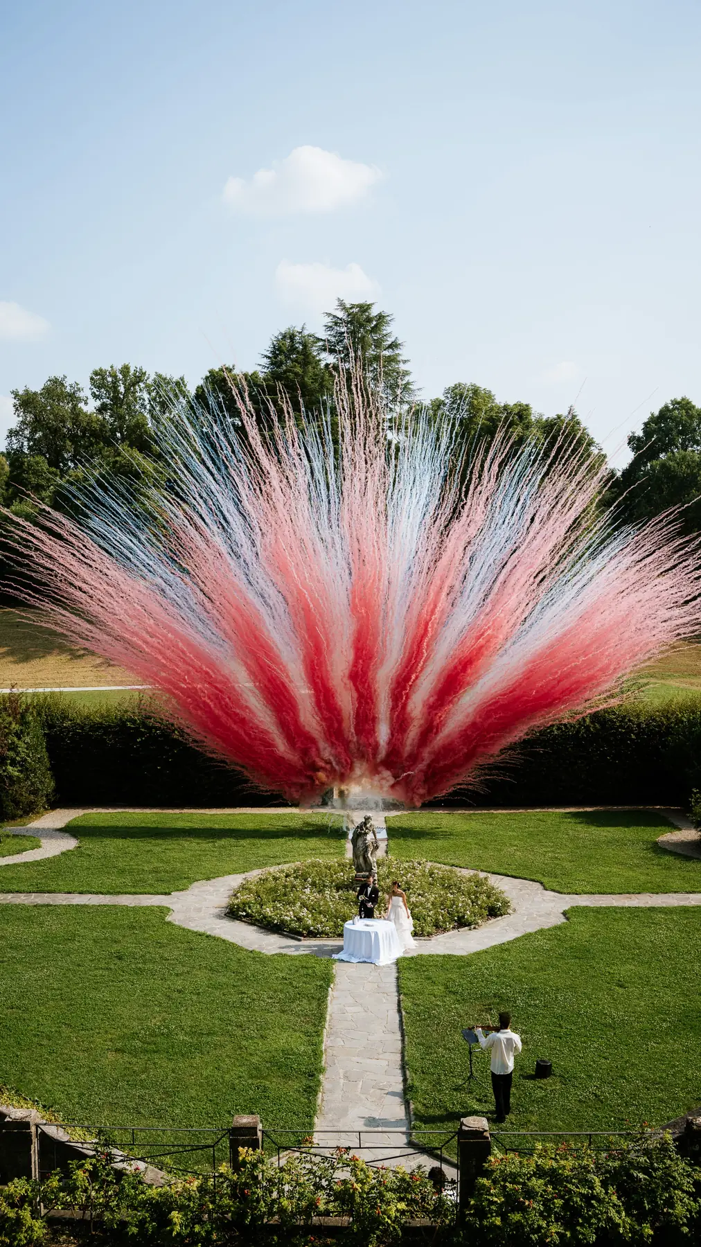 Villa formal garden with a pink floral installation, wedding venue