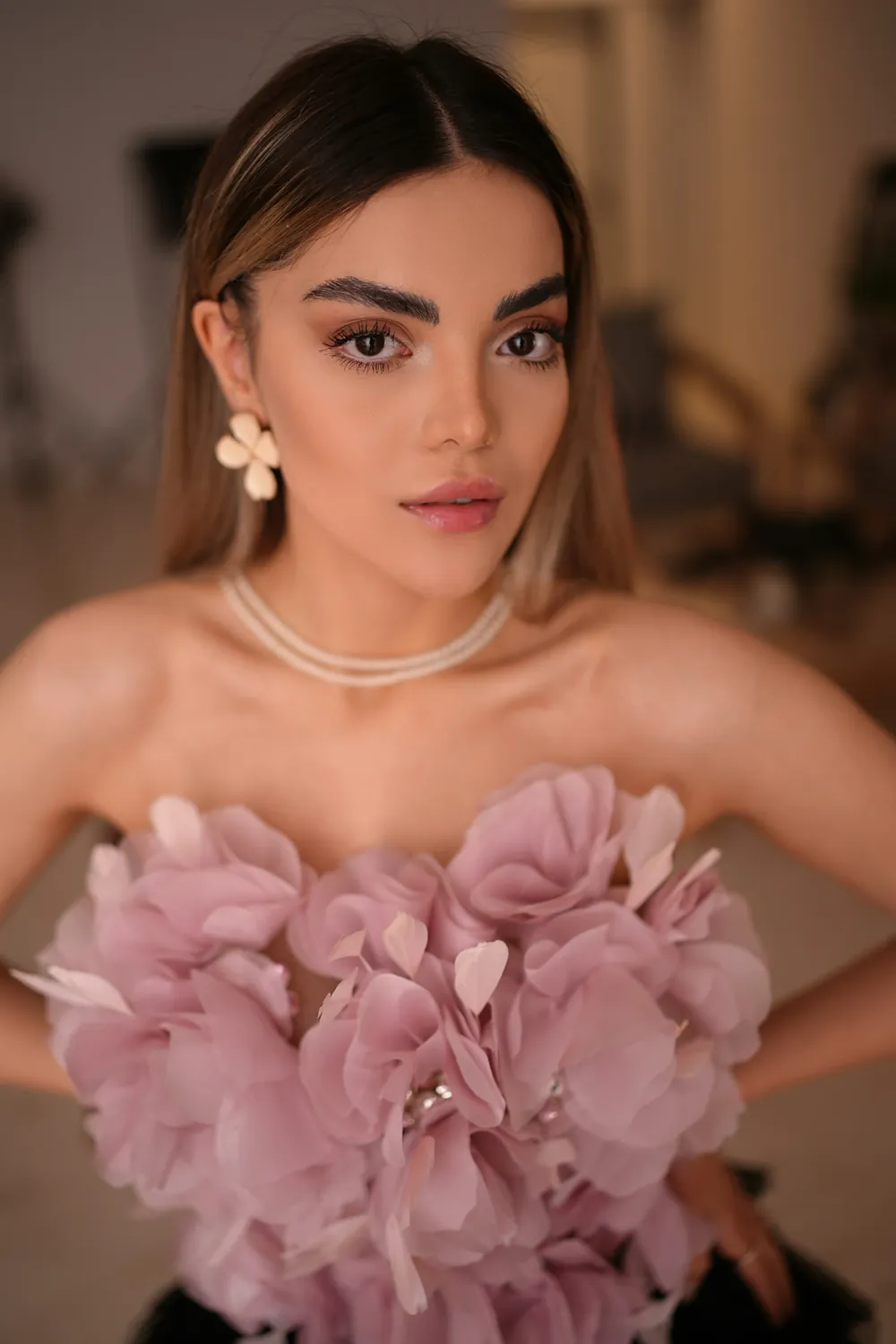 Model in a pink floral strapless dress, fashion styling and makeup look