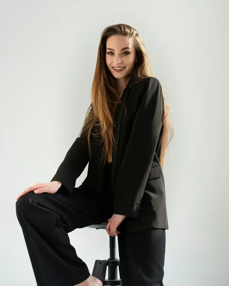 Stand staff member from the Cover Page Agency roster in a black suit