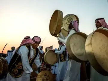 Performers in Emirati national dress