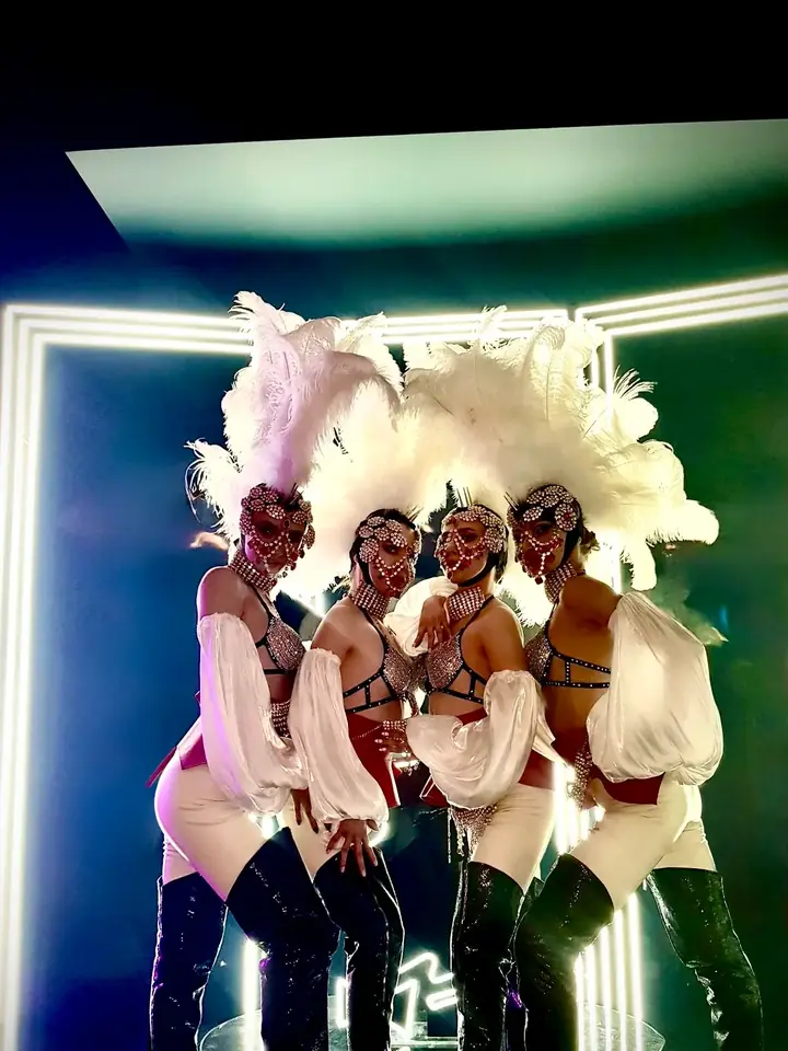 Dancers in feather costumes at a party in Dubai