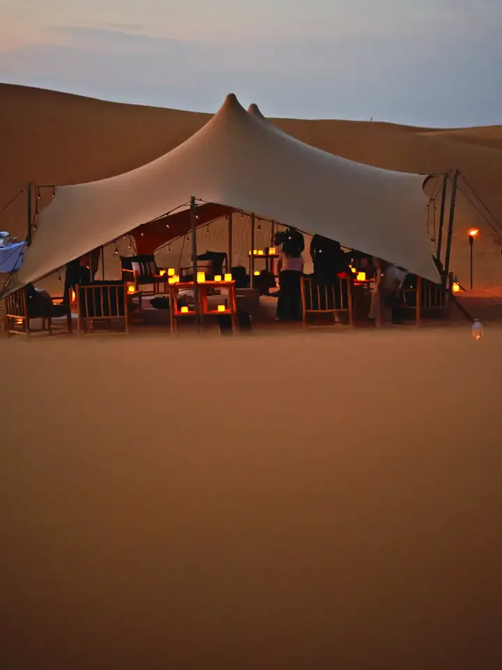 Stretch tent set in the desert near Dubai at sunset
