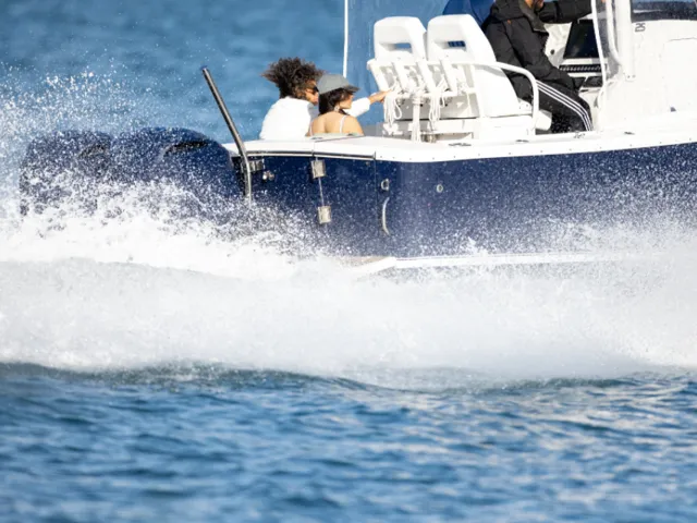 Speedboat at speed throwing spray