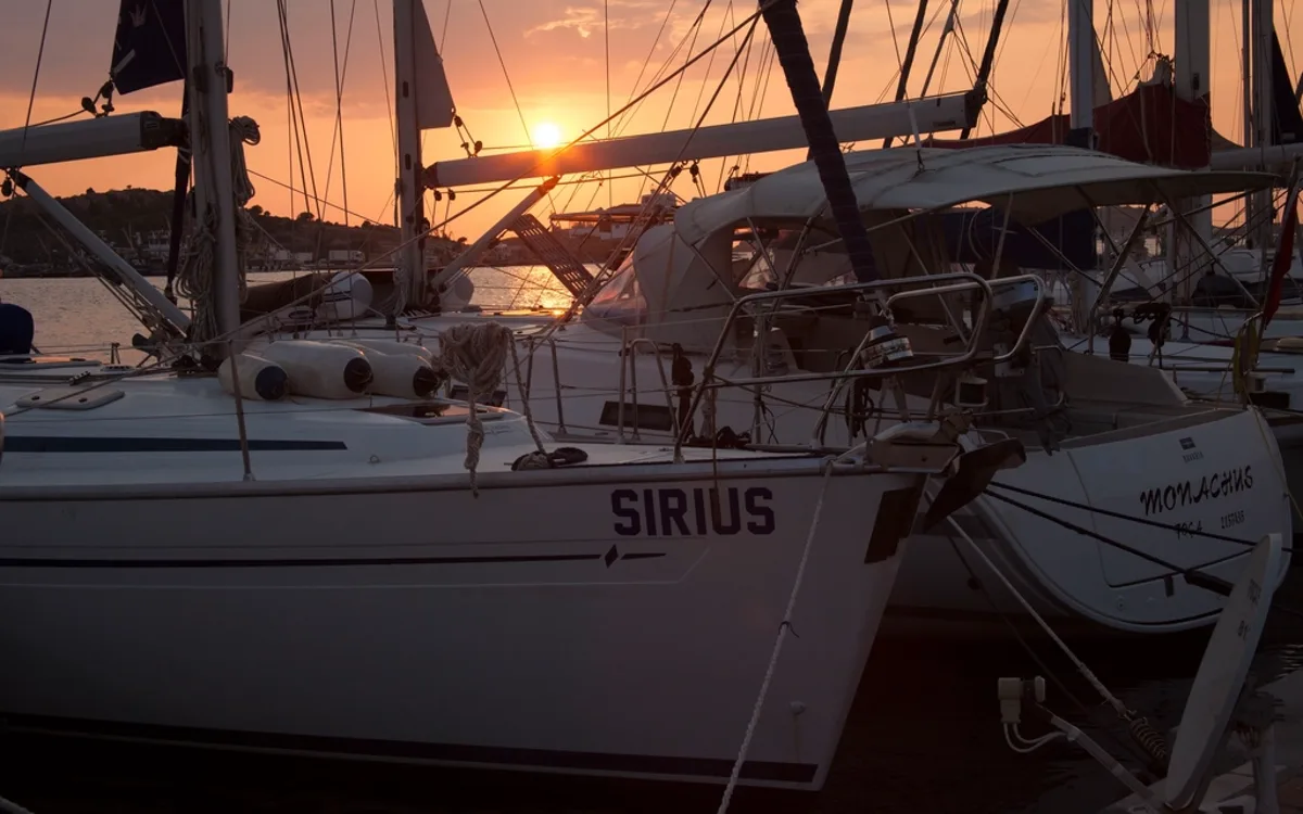 Yachts in a marina at sunset